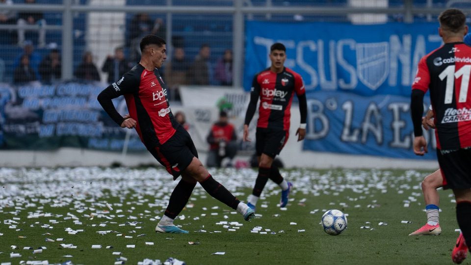 Dynamic scene of soccer players in action during a match with vibrant supporters in the background. Dynamic scene of soccer players in action during a match with vibrant supporters in the background.